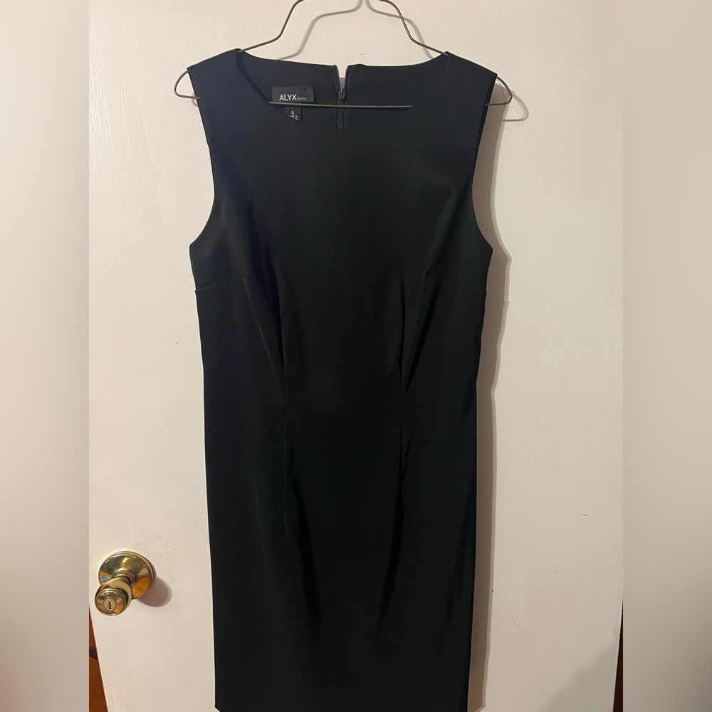 Black dress. Size 6. Business casual. Zips up in the back.